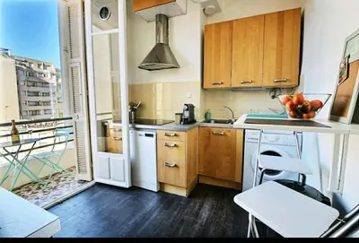 a kitchen with a sink and a stove top oven at Central, climatisé, proche Promenade des anglais. in Nice