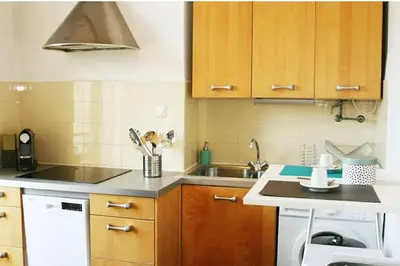 a small kitchen with a sink and a dishwasher at Central, climatisé, proche Promenade des anglais. in Nice