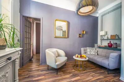a living room with a couch and a chair at LX191 2P design & coloré face gare - Balcon & clim in Nice