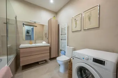 a bathroom with a washing machine and a washer at LX191 2P design & coloré face gare - Balcon & clim in Nice