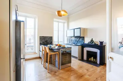 a kitchen with a table and a fireplace in it at LE PALAZZO AP4329 By Riviera Holiday Homes in Nice