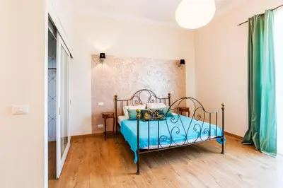 a bedroom with a bed with a blue bedspread at LE PALAZZO AP4329 By Riviera Holiday Homes in Nice