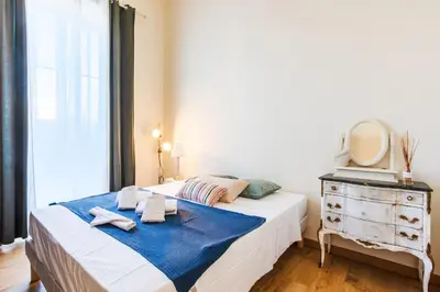 a bedroom with a bed with a mirror and a dresser at LE PALAZZO AP4329 By Riviera Holiday Homes in Nice