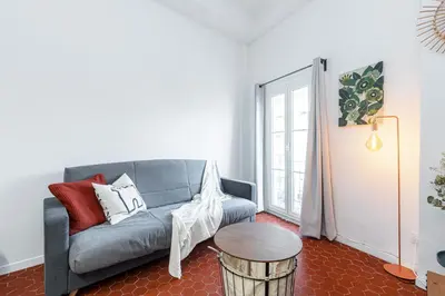 a living room with a couch and a table at Lovely 1 Bdr in Harbor Area in Nice