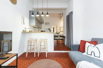 a living room with a couch and a kitchen at Lovely 1 Bdr in Harbor Area in Nice