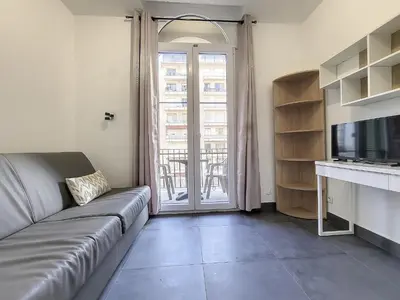 a living room with a couch and a television at Nestor&Jeeves - ROSIE FRANCE RIVIERA - Close sea - Balcony in Nice