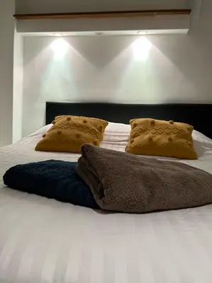 a bed with two pillows and a blanket on it at Romantique - NeaSpace Vieux Nice in Nice