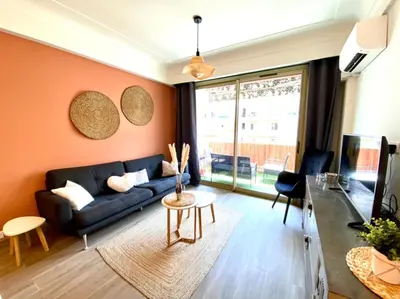 a living room with a couch and a table at Cosy Californie in Nice