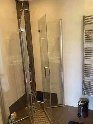 a shower with a glass door in a bathroom at NICE BAIE DES ANGES in Nice