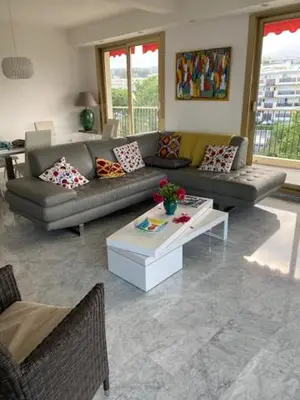 a living room with a couch and a table at NICE BAIE DES ANGES in Nice