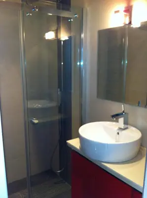 a bathroom with a sink and a shower at NICE BAIE DES ANGES in Nice