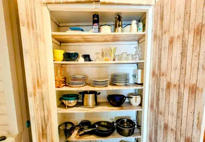 a cabinet filled with dishes and pots and pans at St Joseph · Great holiday flat - old town for 4 in Nice