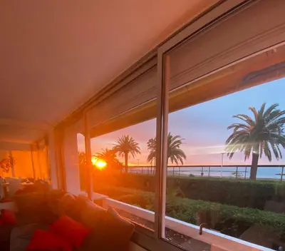 a living room with a window with a view of the ocean at Magnifique appartement les pieds dans l’eau à Nice in Saint-Laurent-du-Var