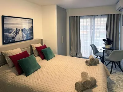 a hotel room with a large bed with towels on it at Beachfront Studio on Promenade des Anglais in Nice