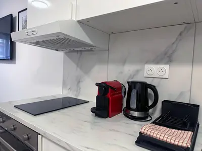 a kitchen with a counter top with a coffee maker at Beachfront Studio on Promenade des Anglais in Nice