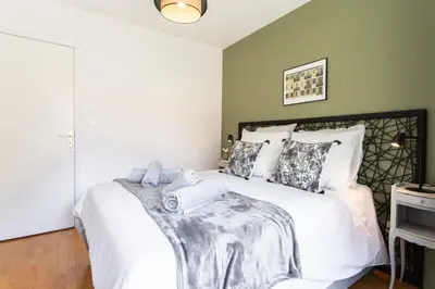 a bedroom with a large white bed with towels on it at #4 Papon Parking climatisé terrasse & wifi 5mins à pieds du Vieux Nice in Nice
