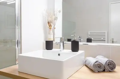 a white bathroom with a sink and a mirror at #4 Papon Parking climatisé terrasse & wifi 5mins à pieds du Vieux Nice in Nice