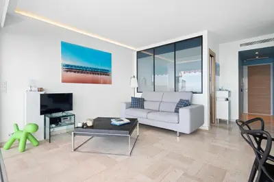 a living room with a couch and a tv at Balcon sur la Méditerranée in Nice