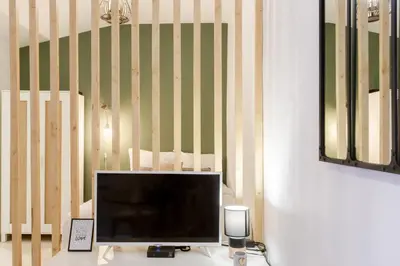 a flat screen tv sitting on top of a desk at Jolie studio - Proche Promenade des anglais in Nice