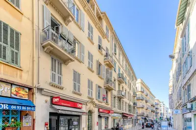 a street in a city with tall buildings at Jolie studio - Proche Promenade des anglais in Nice