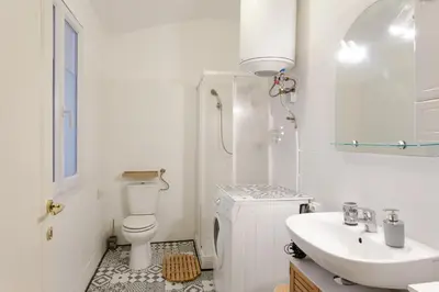 a white bathroom with a toilet and a sink at Jolie studio - Proche Promenade des anglais in Nice
