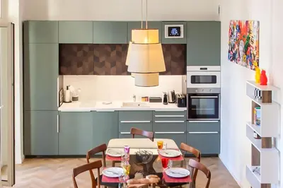 a dining room with a table and chairs in a kitchen at #8 Suite Promenade 1min Beach 2rooms/Parking/Terrace/WIFI in Nice
