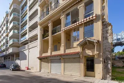 an apartment building with a parking lot in front of it at #8 Suite Promenade 1min Beach 2rooms/Parking/Terrace/WIFI in Nice