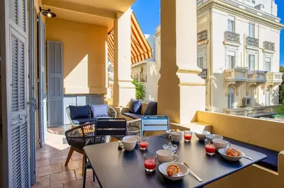 a table with food on top of a balcony at #8 Suite Promenade 1min Beach 2rooms/Parking/Terrace/WIFI in Nice