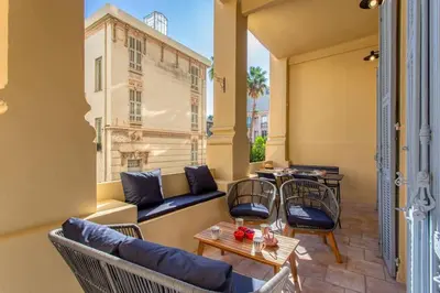 a balcony with a couch and chairs and a table at #8 Suite Promenade 1min Beach 2rooms/Parking/Terrace/WIFI in Nice