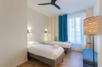 a bedroom with two beds and a ceiling fan at #8 Suite Promenade 1min Beach 2rooms/Parking/Terrace/WIFI in Nice