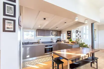 a kitchen with a wooden table and a dining room at #9 Opera's Duplex panoramic Sea View Terrace & AC 1min to Beach in Nice