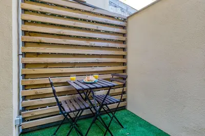 a table and chairs on a balcony with a wall at #14 Duplex Tonduti terrace 5min Old Town in Nice