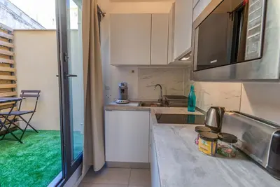 a small kitchen with a sink and a table at #14 Duplex Tonduti terrace 5min Old Town in Nice