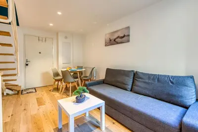 a living room with a blue couch and a table at #14 Duplex Tonduti terrace 5min Old Town in Nice