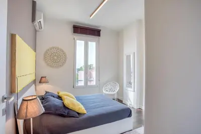 a bedroom with a blue bed and a window at #24 Marie-Claire Suite Sea view/balcony/AC/5min port in Villefranche-sur-Mer