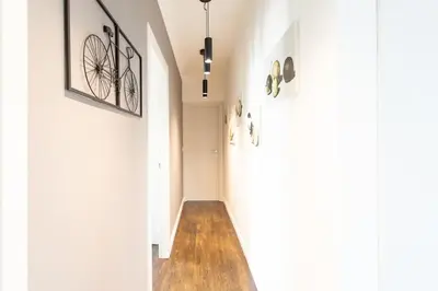 a hallway of a house with white walls and wood floors at #24 Marie-Claire Suite Sea view/balcony/AC/5min port in Villefranche-sur-Mer
