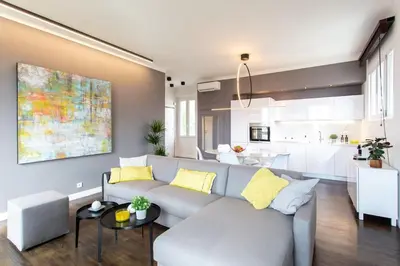 a living room with a couch and a kitchen at #24 Marie-Claire Suite Sea view/balcony/AC/5min port in Villefranche-sur-Mer