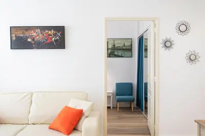 a living room with a white couch and a blue chair at #28 1 BDR Flat AC Balcony Hper Central 10mins to Beach & old town in Nice