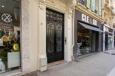 a store front with a black door on a street at #28 1 BDR Flat AC Balcony Hper Central 10mins to Beach & old town in Nice