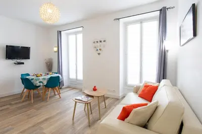 a living room with a couch and a table at #28 1 BDR Flat AC Balcony Hper Central 10mins to Beach & old town in Nice