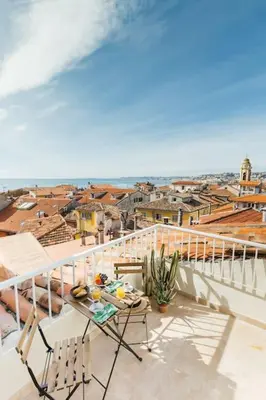 a kitchen with a table and chairs in a room at #32 Panoramic Sea View over Old Town Terrace & AC in Nice