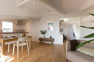 a kitchen and living room with a table and chairs at #32 Panoramic Sea View over Old Town Terrace & AC in Nice