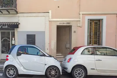 two white cars parked in front of a building at #1 Studio Fontaine de la Ville-WIFI in Nice