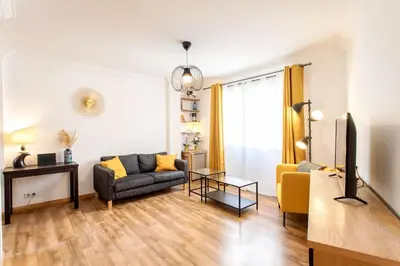a living room with a couch and a tv at #1 Studio Fontaine de la Ville-WIFI in Nice