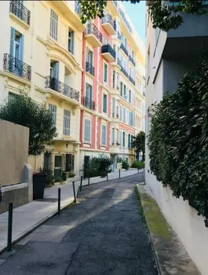 an empty street in a city with tall buildings at Top floor nest, balcony close to sea and old-town Bail Mobilité in Nice