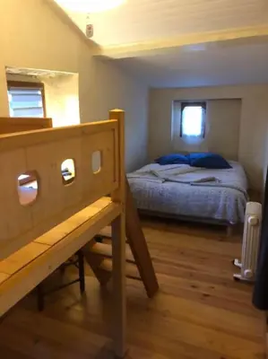 a small bedroom with a bed and a window at Maison de village vue montagne in La Gaude