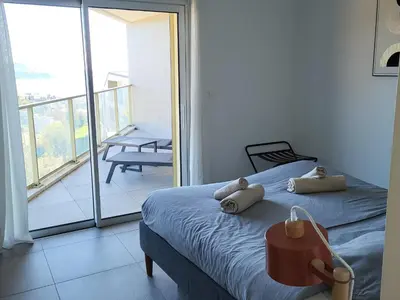 a bedroom with a bed and a white wall at Blue Pearl 102 By Avecoeur in Nice
