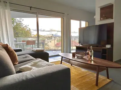 a living room with a couch and a table and a television at Blue Pearl 102 By Avecoeur in Nice