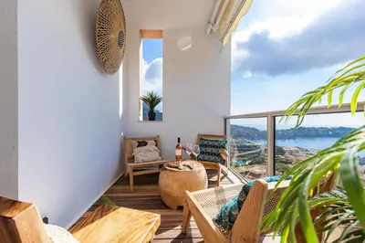 a room with a balcony with a view of the ocean at FEEL HOME - SAFRANETTE in Villefranche-sur-Mer