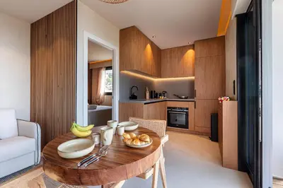 a kitchen with a wooden table with bowls of fruit on it at FEEL HOME - SAFRANETTE in Villefranche-sur-Mer